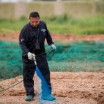 Pest control technician applying a pre-slab termite treatment at a new home site
